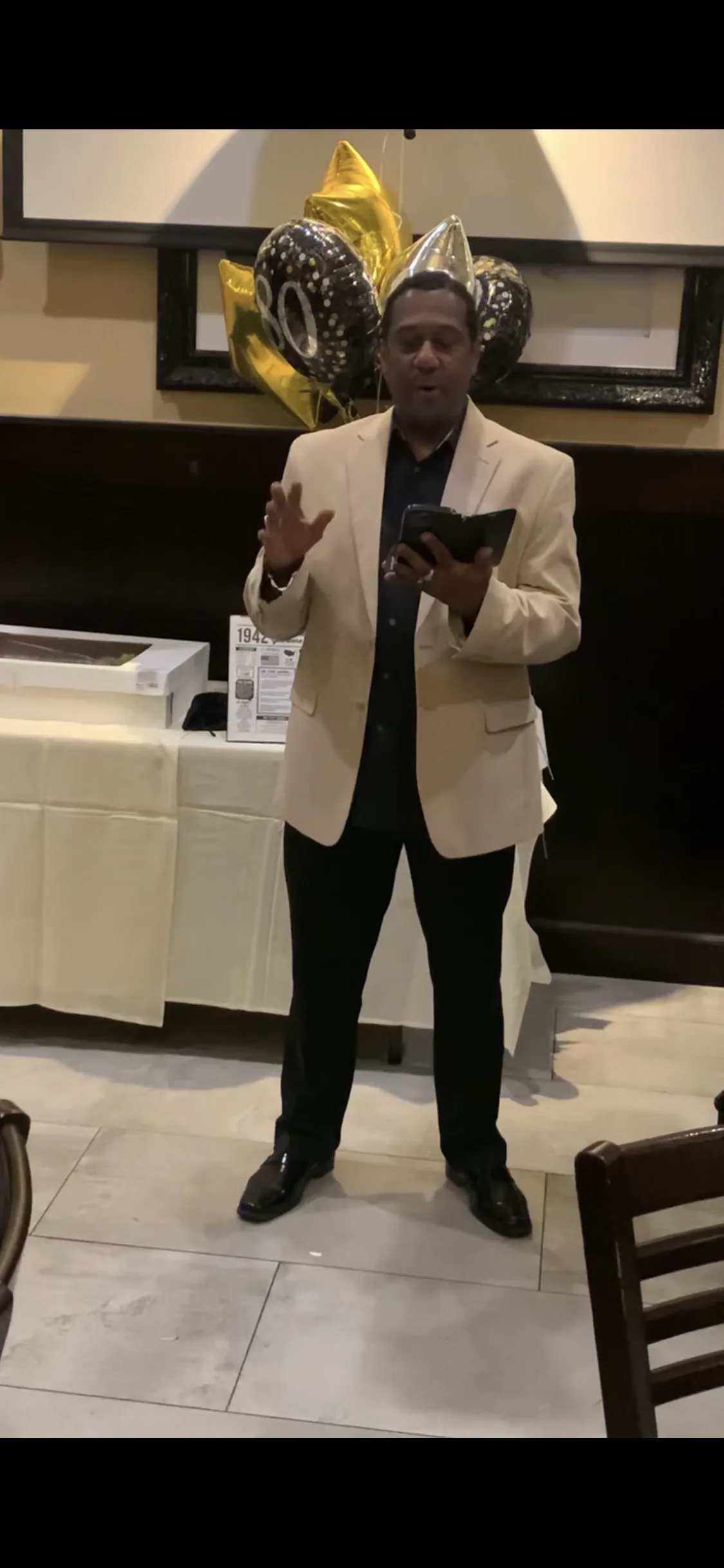 Coach Wilbon speaking at athletic banquet timeline podium photo